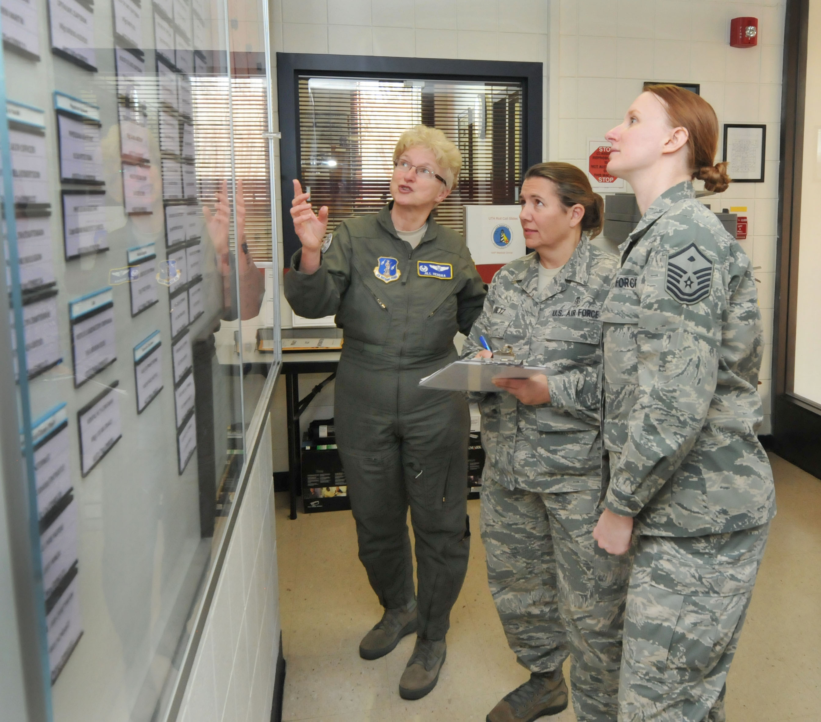 a photo of 145th airlift wing medical professionals looking at a wall of information
