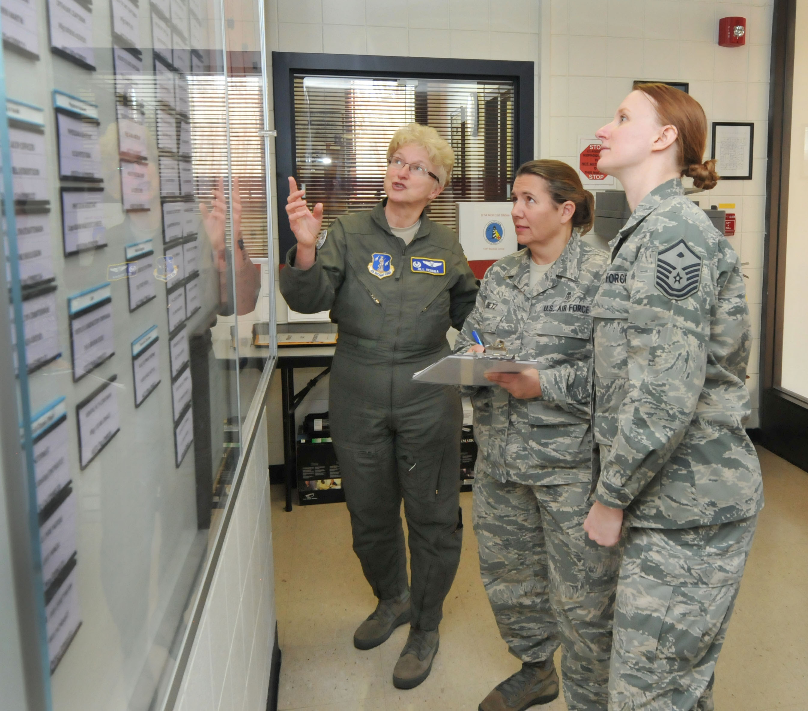 a photo of 145th airlift wing medical professionals looking at a wall of information a photo of 145th airlift wing medical professionals looking at a wall of information