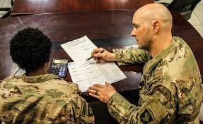 A photo of an Airman receiving financial counseling from another Airman. 