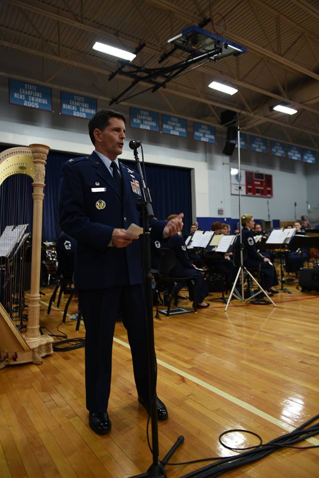 A photo of Col. Troy Gerock a former Commander of the 145th Airlift Wing at a speaking event in the gymnasium of a Charlotte School. 