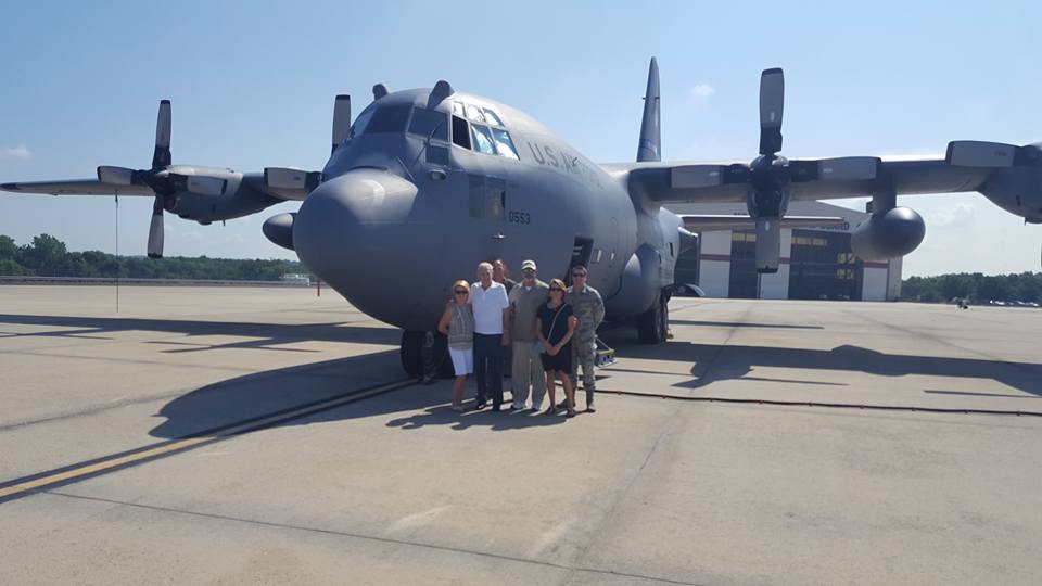 A photo of a small tour group standing in front of a C-17 aircraft on the flightline of the North Carolina Air National Guard