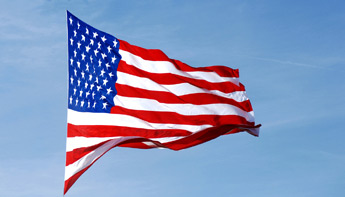 Photo of the American Flag waving on a flag pole
